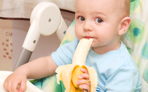 Ребёнок на диете ест банан